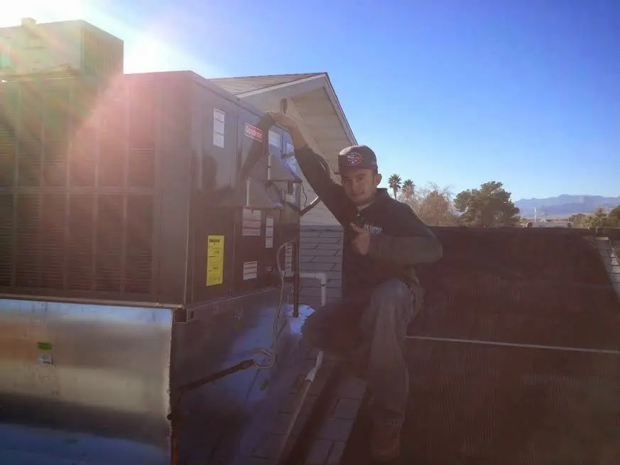 HVAC technician performing Boiler Repair on a rooftop unit in Delaware